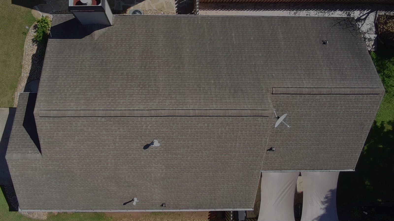 Worn roof with aged shingles, drone view